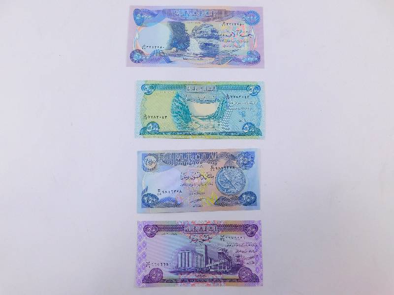 lot 27 image: $5,800 Iraqi Dinar - Lot of 4 Banknotes
