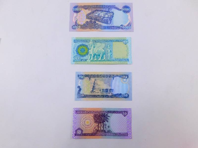 lot 28 image: $5,800 Iraqi Dinar - Lot of 4 Banknotes