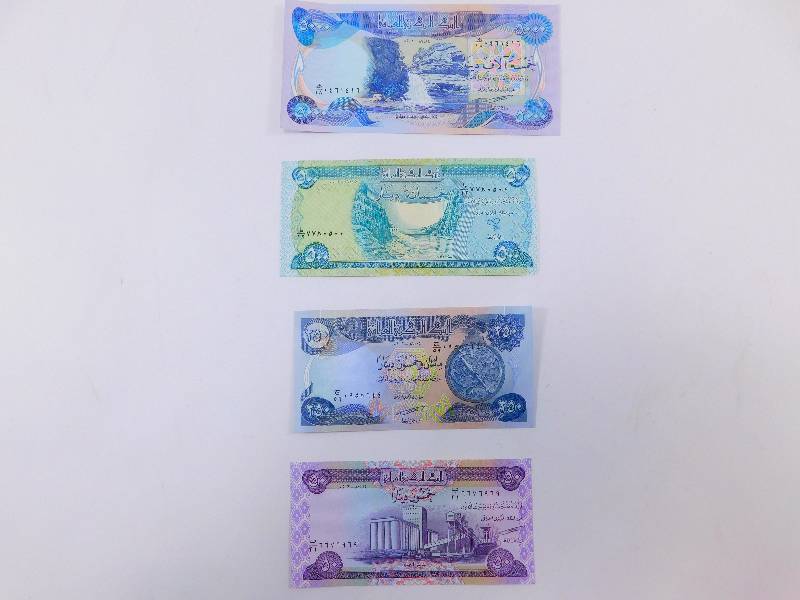 lot 29 image: $5,800 Iraqi Dinar - Lot of 4 Banknotes