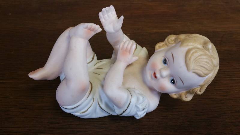 lot 35 image: Stamped KPM Porcelain Piano Baby