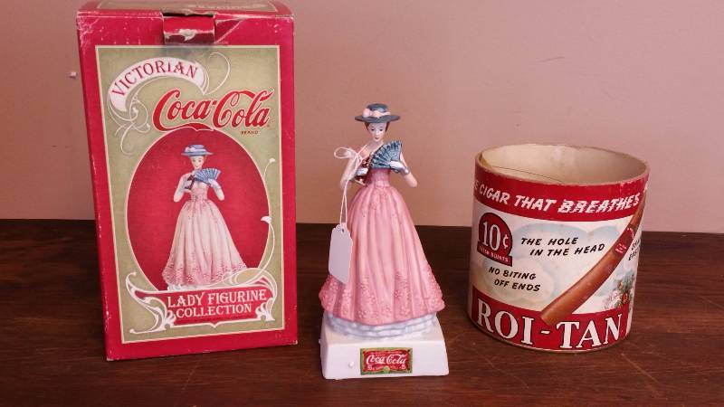 lot 71 image: Coca-Cola Lady Figurine & Roi Tan Cigar Packaging