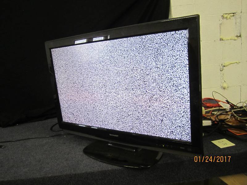 lot 28 image: Sharp 32 Inch LCD TV, powers on...