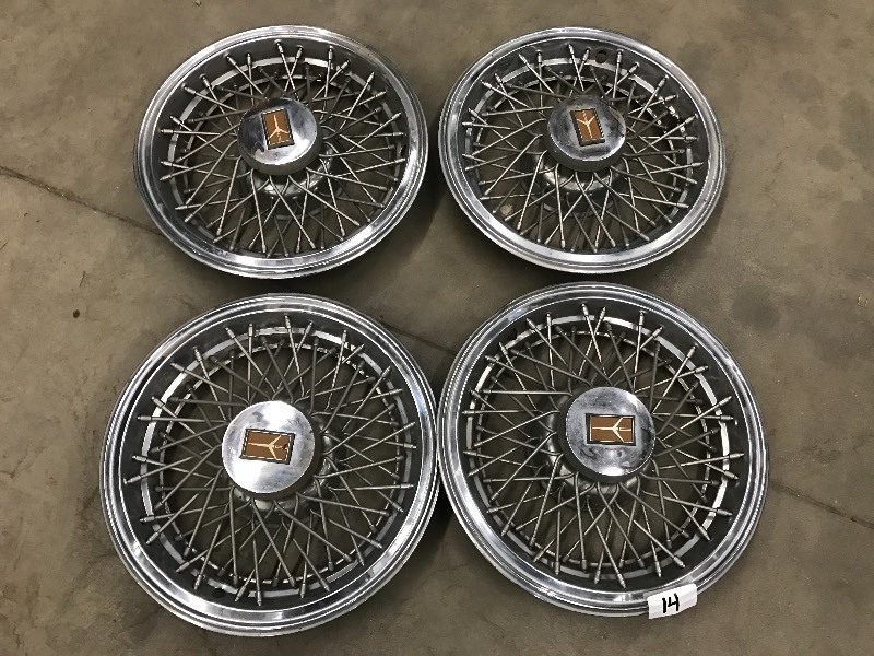 lot 14 image: (4) Oldsmobile Cutlass Hub Caps ...