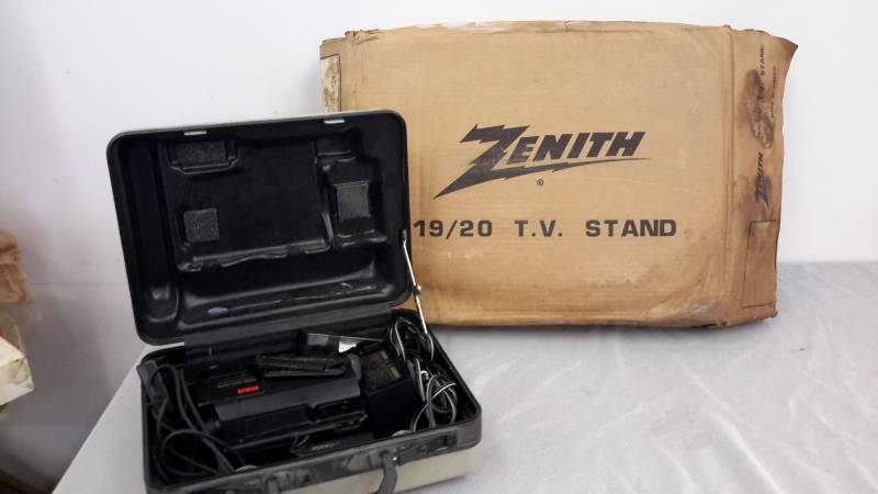lot 18 image: RCA camcorder, batteries, charger, Zenith TV stand new in the box