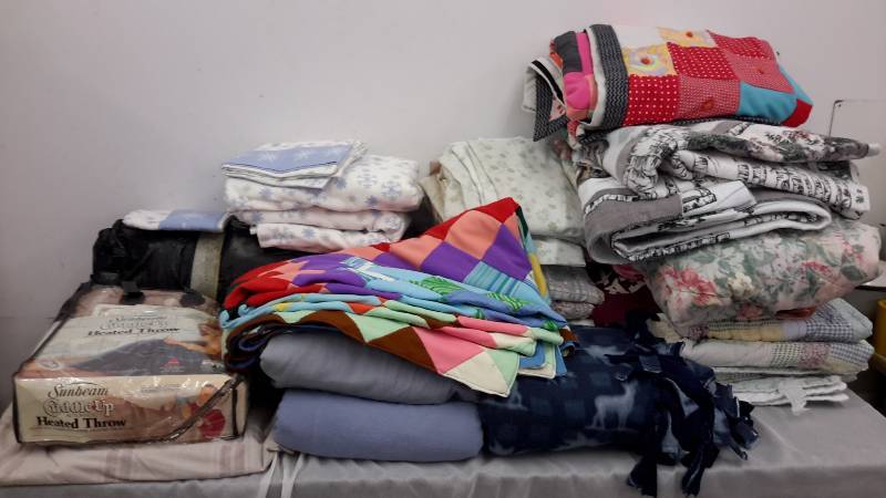 lot 76 image: Quilts, flannel sheets, bedding, and more