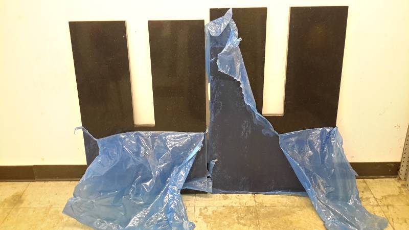 lot 97 image: 2 oddly cut pieces of granite countertop
