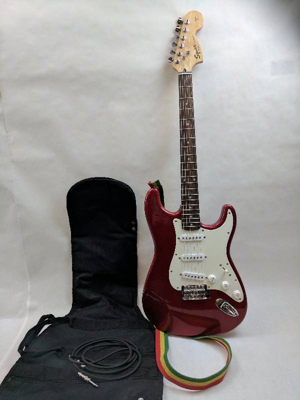 lot 13 image: Squier Standard Stratocaster Electric Guitar Candy Apple Red Maple Fretboard with soft case