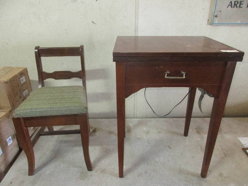 vintage sewing machine by white  and chair