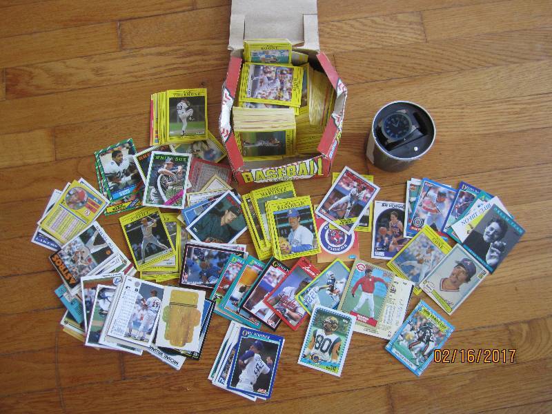 Box of sports cards and a watch wit...