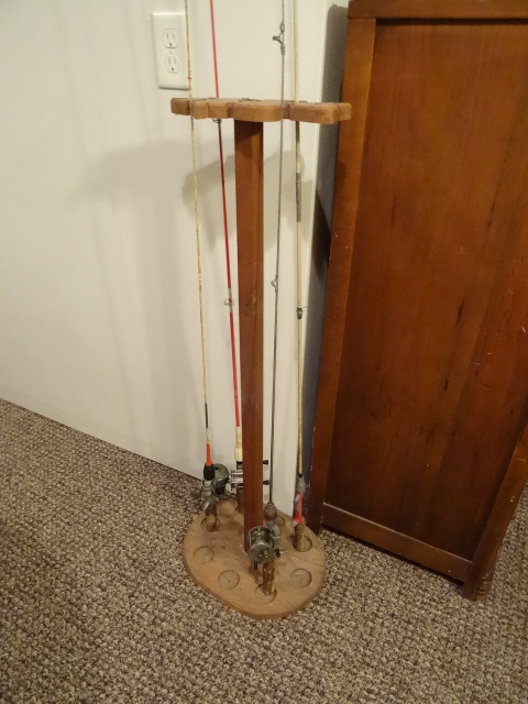 lot 188 image: Fish pole stand with 4 vintage rods...
