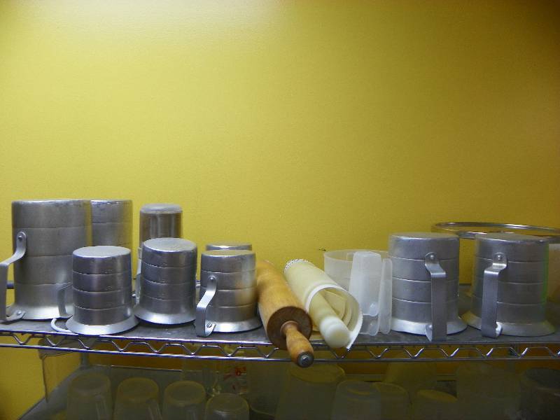 kitchen items, metal measuring pitchers and rolling pins