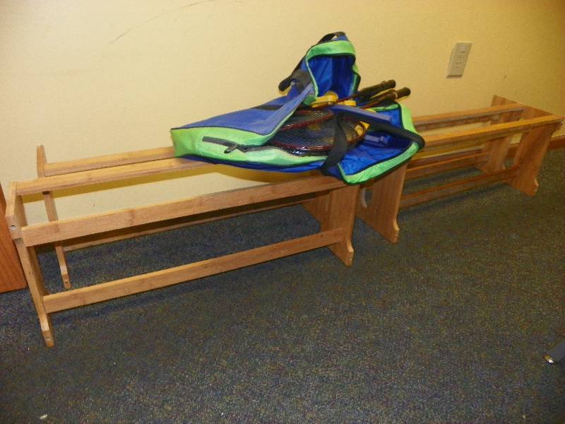 Wooden racks and bag of sports items