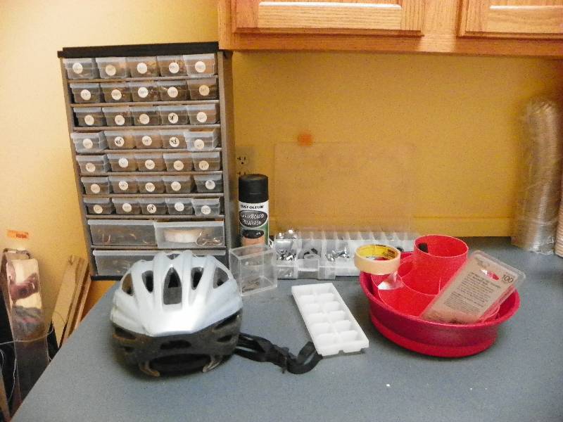Small hardware storage unit with drawers, bike helmet