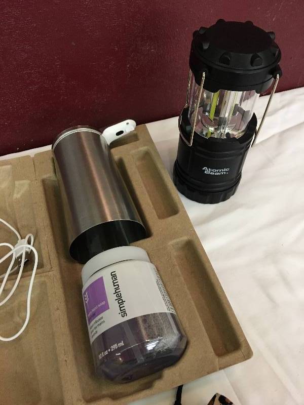 lot 32 image: soap dispenser,electric drumsticks,atomic light