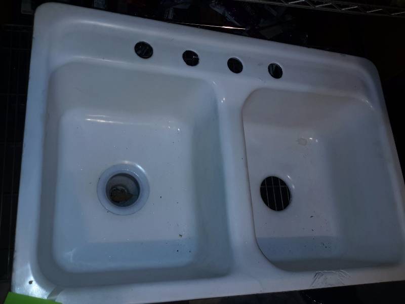 Cast IronEnamel Kitchen Sink.. Some damage on front edge.