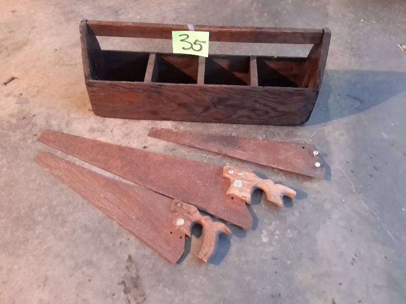 Very old hand saws and very old wood tool box