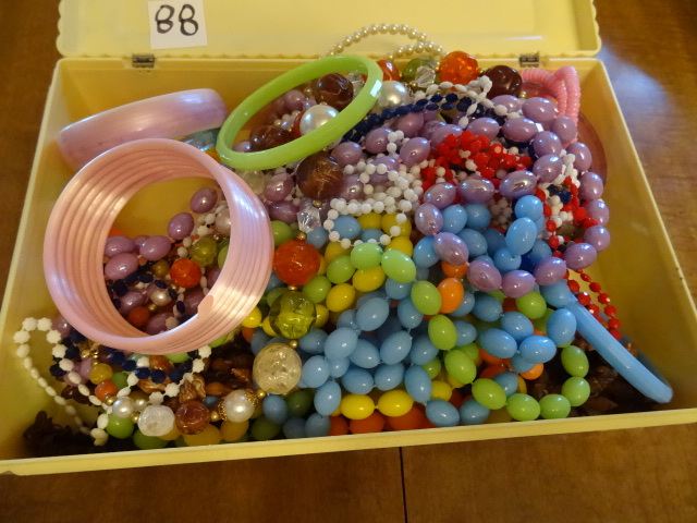 lot 88 image: Plastic box filled with plastic cos...