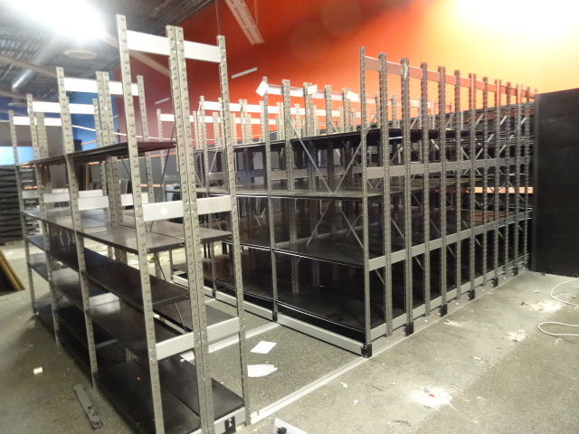 lot 22 image: Sliding shelving unit. 15 shelves s...