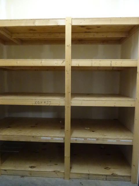 lot 57 image: Wood shelving unit. L shaped. Mostl...