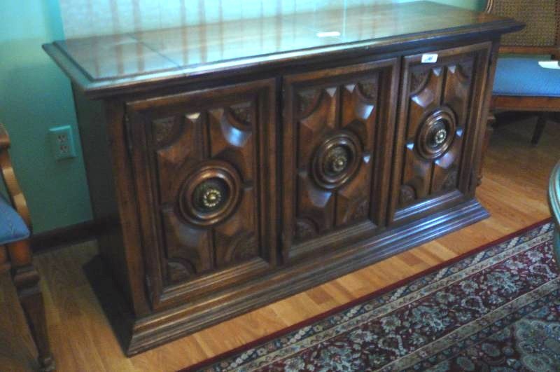 lot 24 image: Oak Buffet with 3 doors, a silverware drawer. 57 12 w x 19 deep x 30 tall (BUFFET ONLY ITEMS INSIDE NOT INCLUDED)