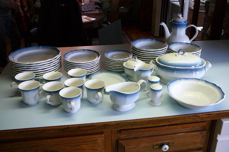 lot 33 image: Country Club Mikasa Dishs, Oven to Table  8 big Plates, bowls, 8 small Plates, Bowls, 8 cups, 8 coffee plates, 1 serving bowl 1 serving bowl with cover, 4 salt shakers, creamer, gravy server, sugar server.