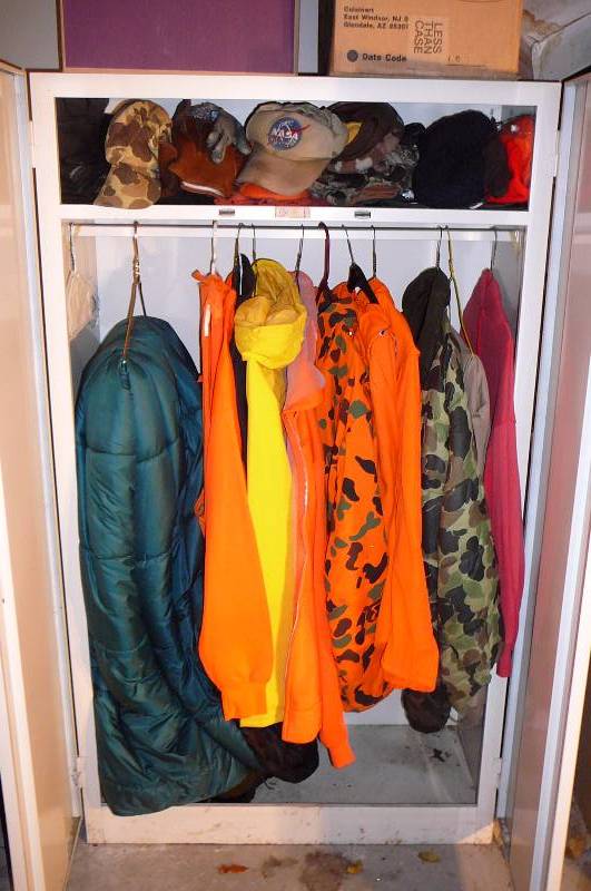 lot 469 image: Steel Cabinet 36 w x 63 t x 19 12 d with Jackets and sweat shirts, Orange vest, Yellow Rain jacket, Green Nylon sleeping Bag, Boots 14, Hats, Gloves, Mittens, Camo,XL - 2X