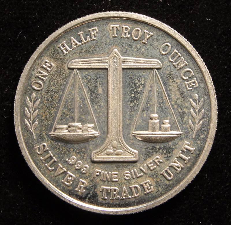 lot 89 image: 12 TROY OZ. .999 FINE SILVER JESSE HELMS SILVER TRADE UNIT