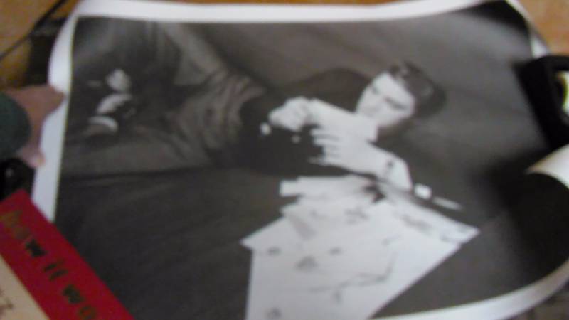lot 234 image: Elvis at 21 Reading Fan Mail Print, by Alfred Wertheimer.