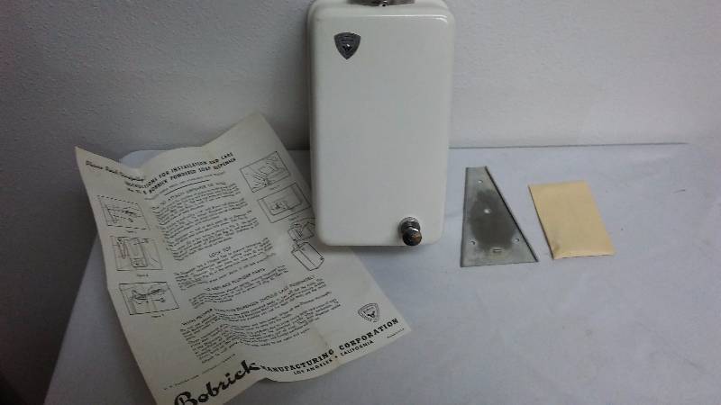 lot 631 image: New OLD STOCK Vintage Bobrick Soap Dispenser, wrapped in newspaper dated 03011951, L.A. Times, complete with instructions.  Bobrick was located in L.A. Cal.  Model 318