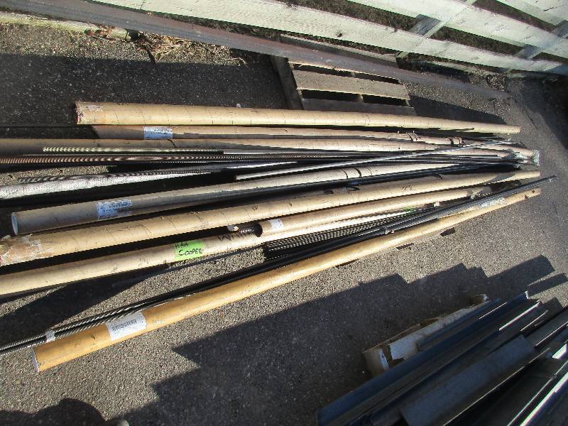 pallet of threadded rods and couple pieces of smooth rod 1 piece of 13x 2 x 1.25 solid bar