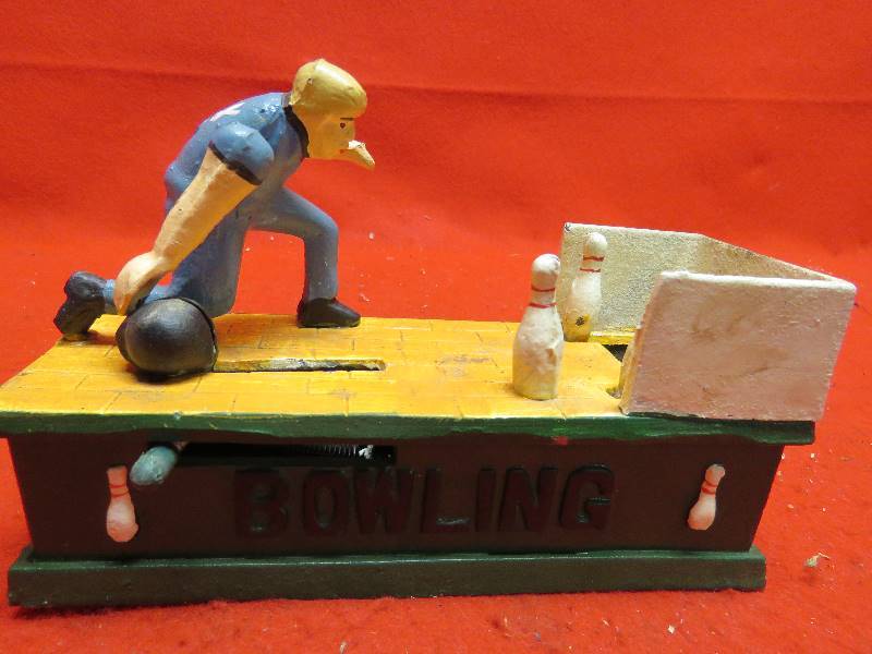 lot 233 image: Vintage Cast Iron Bowling cast iron bank