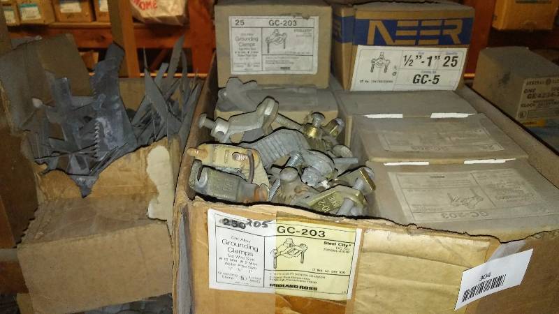 lot 304 image: Boxes of Grounding Clamps (9) 25 per box plus loose ones, Switch Box Supports, box of 500 sets, mostly full.