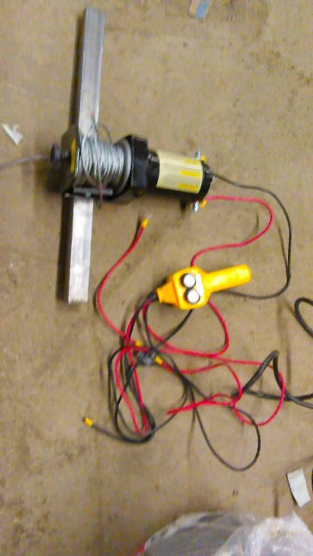 lot 642 image: Portable 2000 lb. 12V Winch Trakker Brand used once