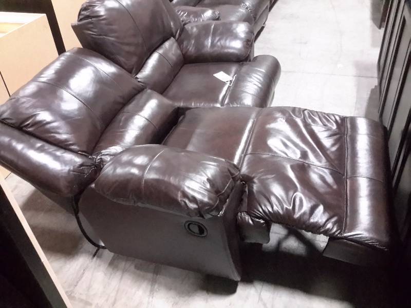 Simulated leather reclining Love Seat.. Mechanically reclines..