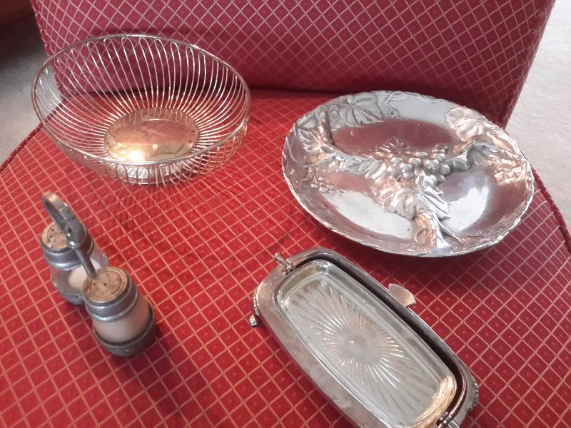 lot 54 image: Very old set of salt and pepper  Metal Bread basket,  Pewter like serving platter, Silver Plate Butter dish with glass insert.