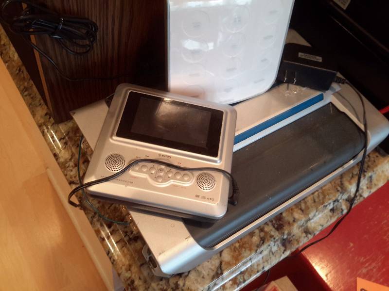 lot 63 image: Misc. electronics as pictured. See closeups.. 2 portable DVD players.. Take it all.
