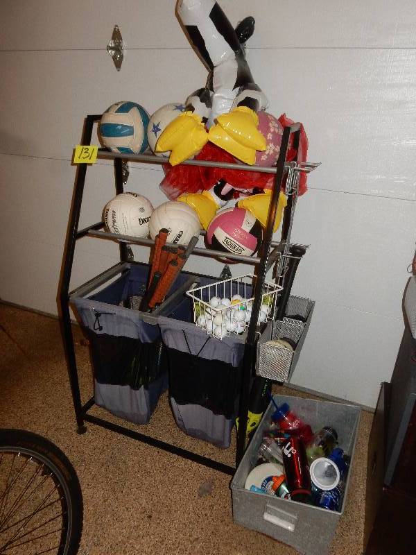 lot 131 image: Sports equipment Rack. Balls and everything shown included.. Includes the KEMPS COW.. See closeup pictures for all included