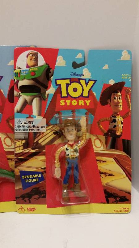 lot 104 image: All Four Toy Story Action Figures in their Original Packaging - Woody, Buzz, Rex and Hamm