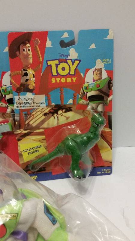 lot 106 image: Toy Story Lot of (5) Collectibles - Woody, Buzz and Rex in Original Packaging