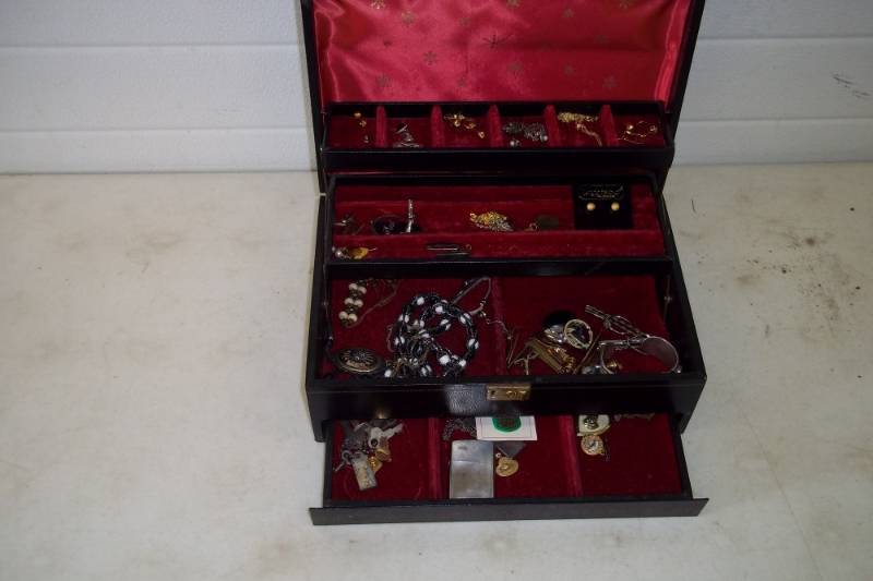 lot 53 image: jewelry box  with jewelry and tie clips, 1950s zippo lighter
