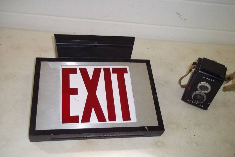 lot 85 image: Exit sign(double sided & lighted) and Ansco readyflex camera