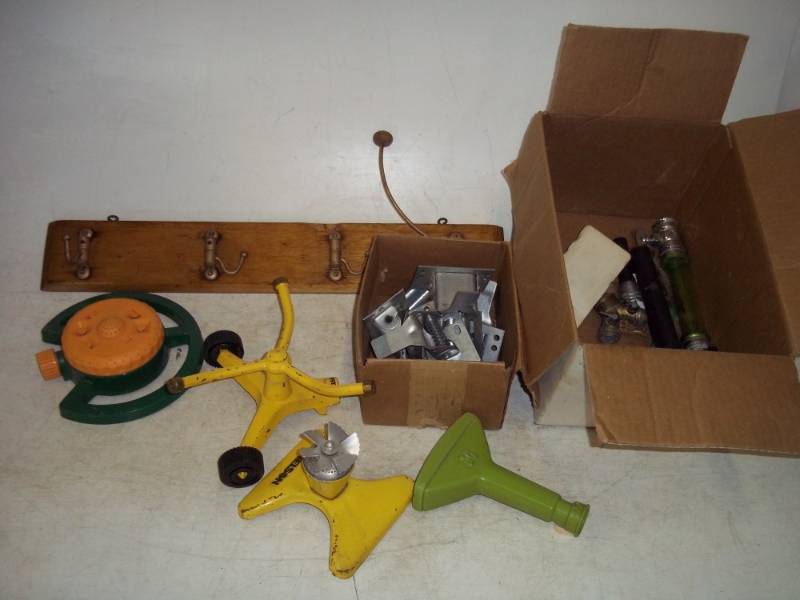 lot 195 image: Box of lawn sprinklers, garage door latches, rack