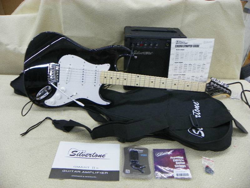 lot 486 image: Silvertone electric guitar and Amp, and other accessories pictured