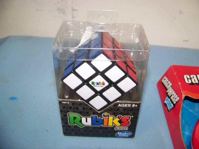 lot 20 image: Rubiks Cube, Catch Phrase Decades and (4) Yahtzee, Hand-Held Games in Original Packages