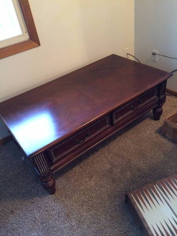 lot 220 image: Beautiful Solid Wood Mahogany Cherry Carved Wood With Decorative Hammered Nail Accents & Intentional Distressed Style Coffee Table With 2 Felt Lined Drawers - Beautiful Condition - 28x19x50 - Needs Very Little Polishing