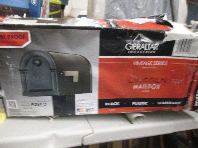 lot 360 image: black plastic mail box and a univer...