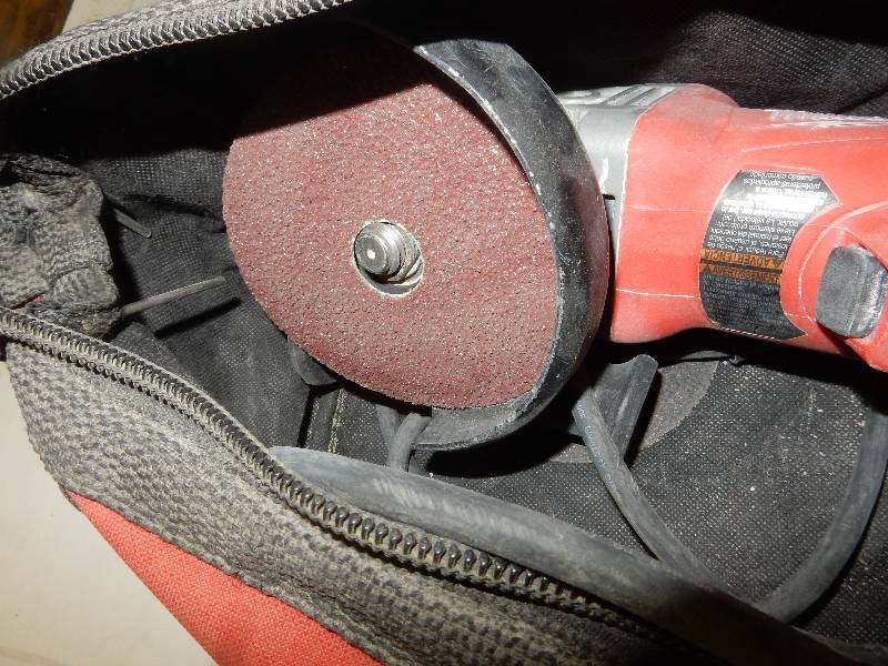 lot 77 image: Milwaukee, 4 12 in Angle Grinder. Appears to be missing the nut to hold grinder on