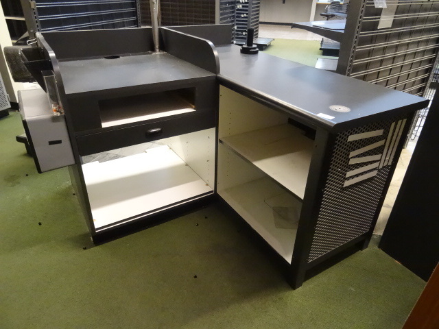 lot 2 image: L Shaped check out counter. 55 x 61 x 40. One drawer. Slot for cash drawer. Lighted sign