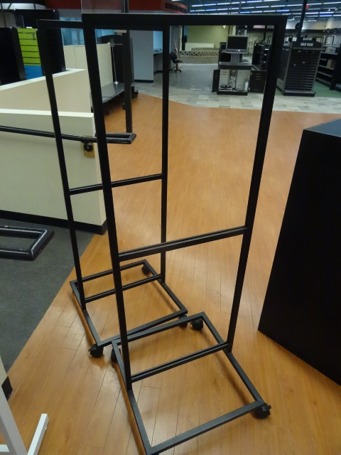 lot 32 image: 2 retail sign holders on wheels. 23 x 24 x 63. Qty 2