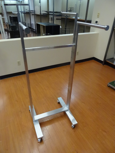 lot 34 image: 4 arm clothing rack on wheels. Adjustable height arms. 24 x 33. Qty 2
